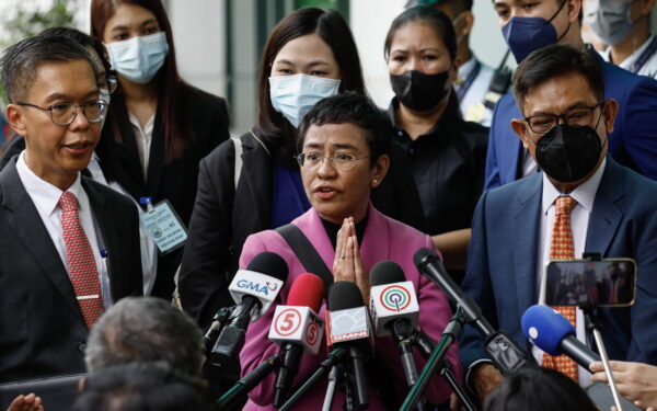 epa10412077 Nobel Peace Prize laureate Maria Ressa (C), the CEO of online news site Rappler, speaks to journalists outside the Court of Tax Appeals in Quezon City, Metro Manila, Philippines, 18 January 2023. The tax court acquitted Ressa and Rappler Holdings Corporation of four tax evasion charges that were filed in 2018 during the term of former Philippine president Rodrigo Duterte.  EPA/ROLEX DELA PENA