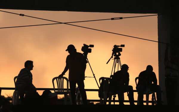 epa06912856 Journalists work at sunset during the water polo qualifier between Costa Rica and Venezuela during the 23rd Central American and Caribbean Games, in Barranquilla, Colombia, 26 July 2018.  EPA/Ricardo Maldonado Rozo