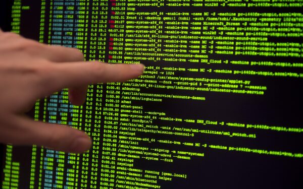 epa04521585 An employee points to code on a screen at Hewlett Packard's cyber defence center in Boeblingen, Germany, 09 December 2014. It will protect German clients from cyber crime in the future. The Boeblinger cyber defense center is one of nine run by HP worldwide.  EPA/DANIEL NAUPOLD